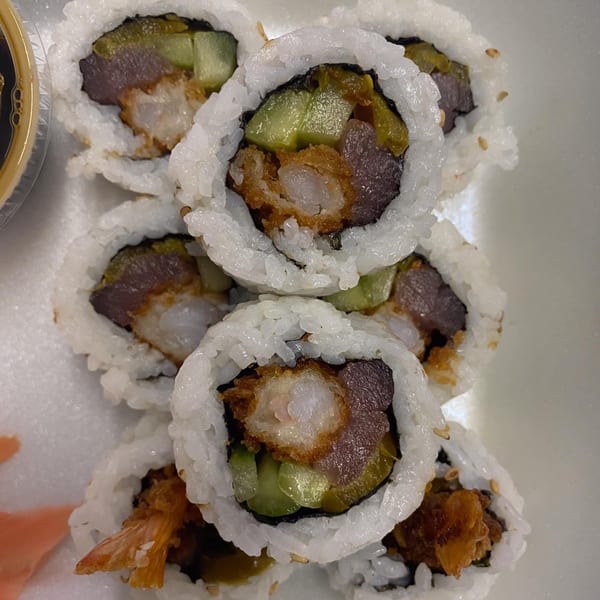 Close-up of Maui Teriyaki and Sushi's shrimp tempura and tuna sushi rolls with cucumber and soy sauce.