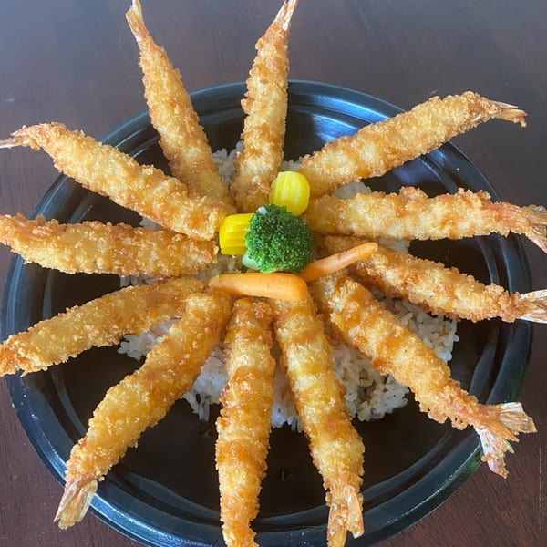 Maui Teriyaki and Sushi's fried shrimp tempura arranged in a circle with rice and vegetables.
